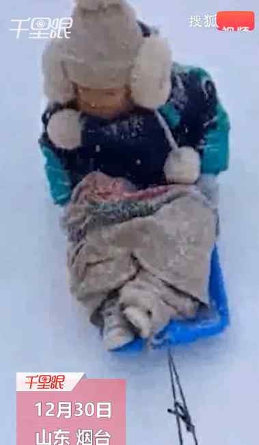 萌娃为拿全勤奖坚持冒雪上学 妈妈用雪板拖行送上学 头发结冰