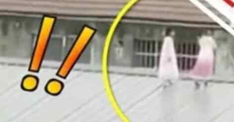 居民无意中瞅见对面楼顶好像有人 仔细一看吓得赶紧报警