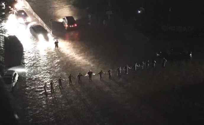 北京强降雨被淹 武警官兵暴雨中筑人墙